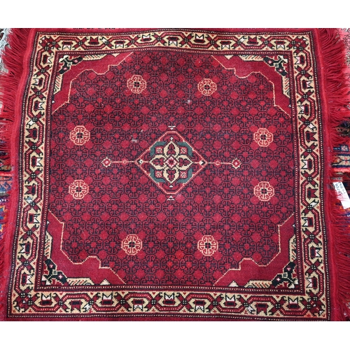 573 - A Chinese blue and white small Peking rug of typical design, 89 x 52 cm to/w a Moroccan red ground r... 