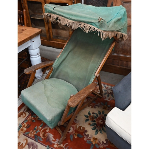 574 - An adjustable folding teak steamer chair with green canvas sunshade, sling, cushion and foot rest