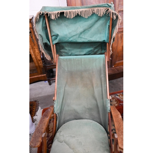 574 - An adjustable folding teak steamer chair with green canvas sunshade, sling, cushion and foot rest