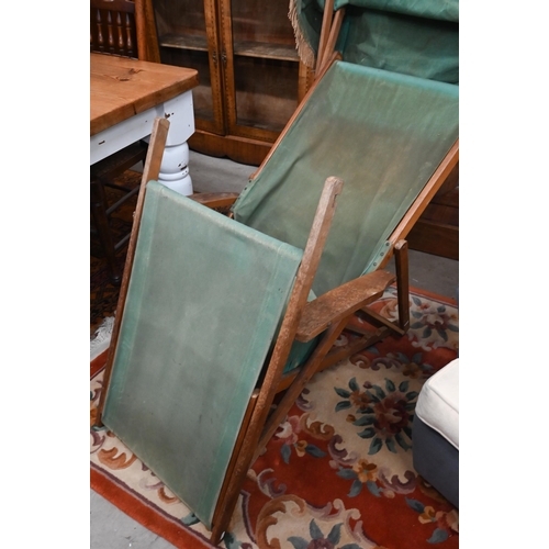 574 - An adjustable folding teak steamer chair with green canvas sunshade, sling, cushion and foot rest