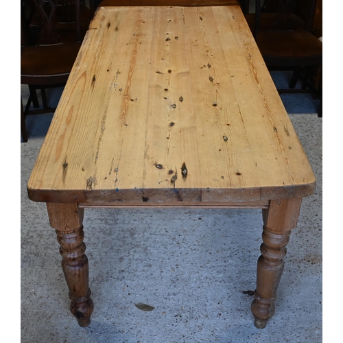 598 - A pine kitchen table raised on turned legs, 183 x 84 x 79 cm h