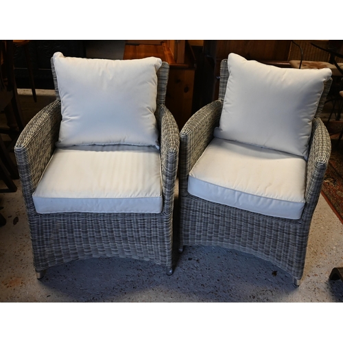 600 - A pair of contemporary wicker style garden armchairs with weatherproof cushions (2)