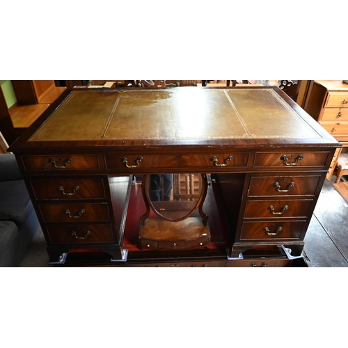 603 - A large twin pedestal mahogany desk with pale  green leather top over an arrangement of nine dr... 