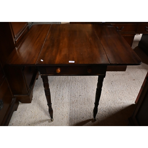 609 - A Victorian mahogany drop leaf Pembroke table raised on turned legs to castors