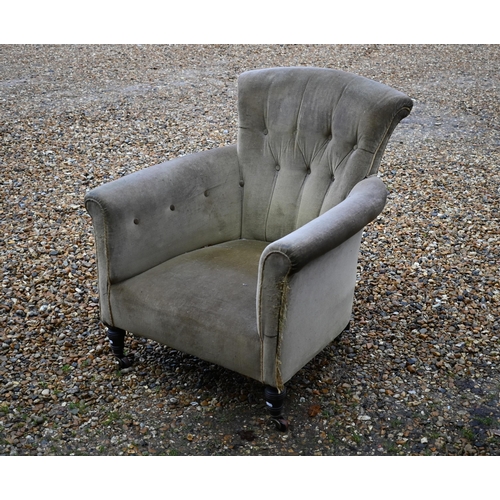 618 - A Victorian green button back armchair, on ceramic castors