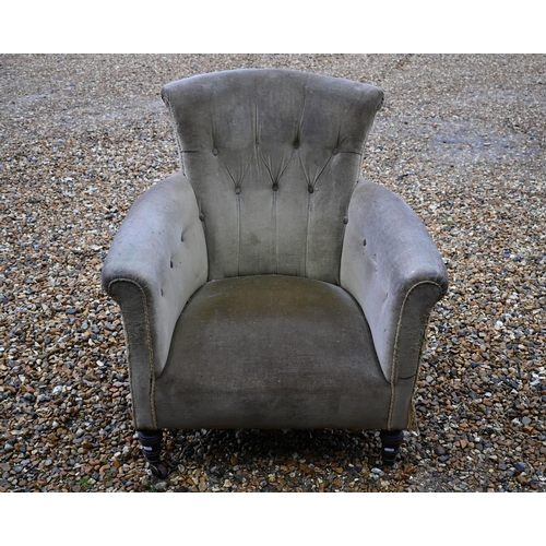 618 - A Victorian green button back armchair, on ceramic castors