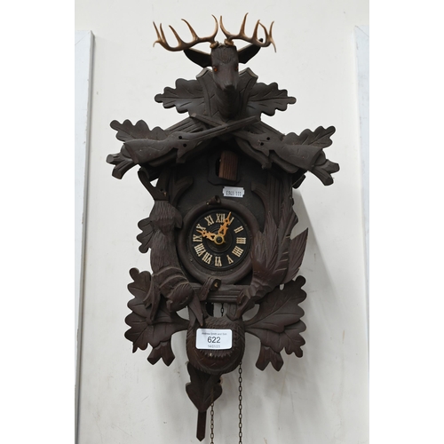 622 - A West German Black Forest style small cuckoo clock (A/F) carved with animals and surmounted by the ... 