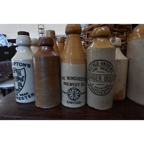 78 - Collection of ten vintage stoneware flagons - all impressed or printed for Winchester vintners/brewe... 