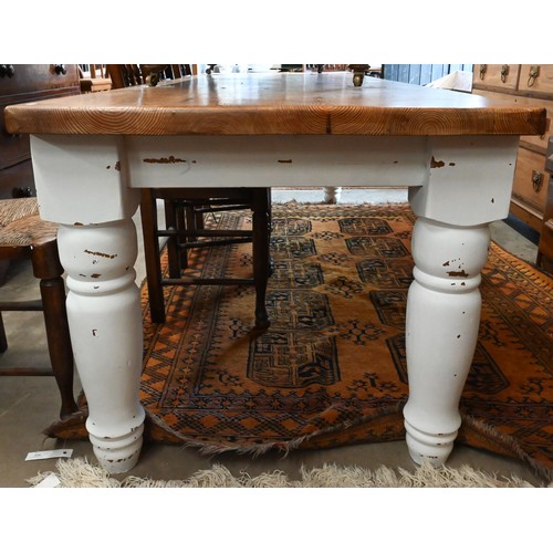 451 - A rustic farmhouse dining table with waxed pine rectangular top on distressed white painted base