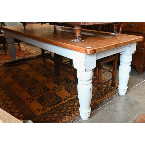 451 - A rustic farmhouse dining table with waxed pine rectangular top on distressed white painted base