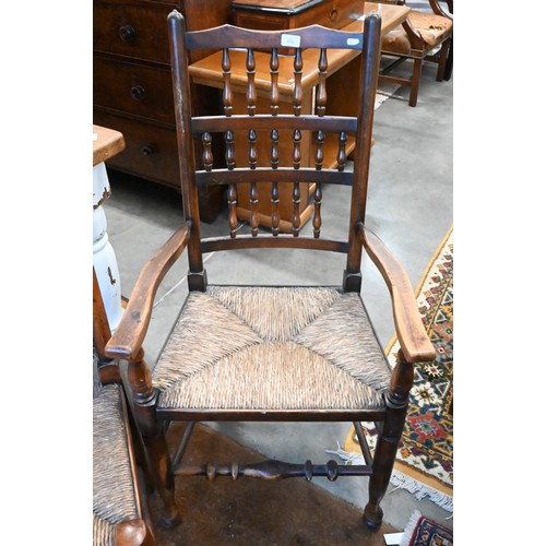 452 - A set of ten 20th century oak Lancashire spindle back dining chairs with woven rush seats, eight sta... 