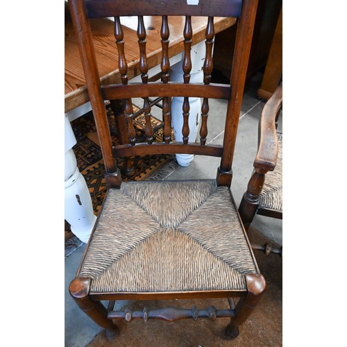 452 - A set of ten 20th century oak Lancashire spindle back dining chairs with woven rush seats, eight sta... 