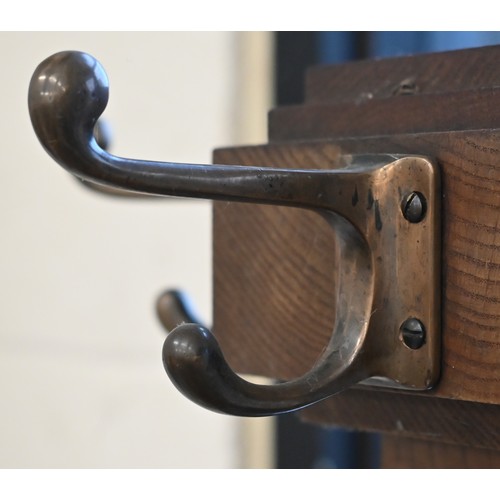 276 - An Arts & Crafts period oak hall stand with brass hooks and stick/umbrella retaining brackets, o... 