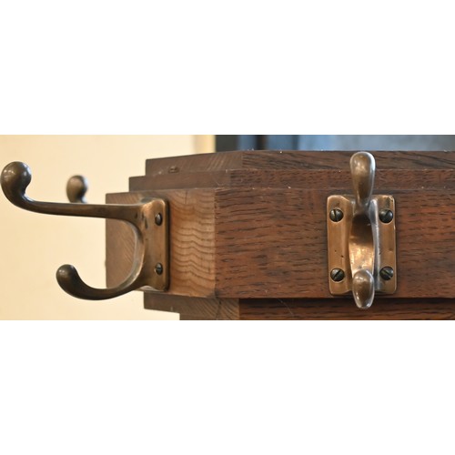 276 - An Arts & Crafts period oak hall stand with brass hooks and stick/umbrella retaining brackets, o... 