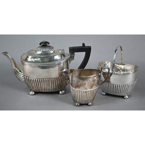 74 - Victorian silver three-piece bachelor tea service of half-fluted oblong form, on later plated bun fe... 