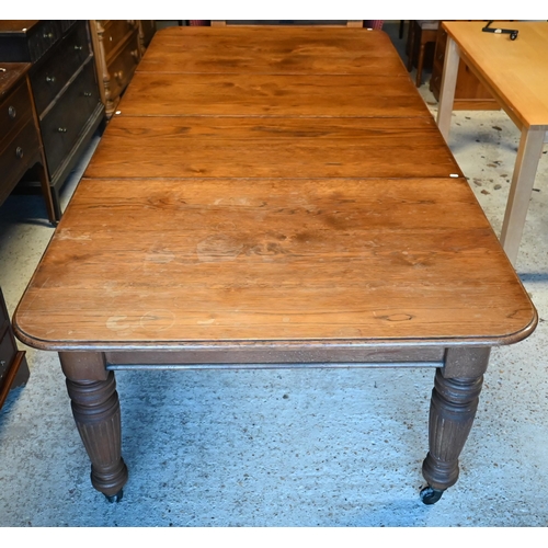 10 - A Victorian oak extending (wind action) dining table, the moulded edge with two leaves (slightly war... 