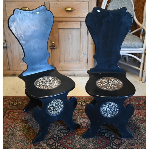 15 - A pair of George II style ebonised and faux marble panelled hall chairs (2)