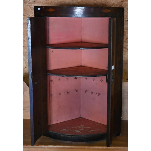43 - An antique crossbanded oak bow front hanging corner cupboard
