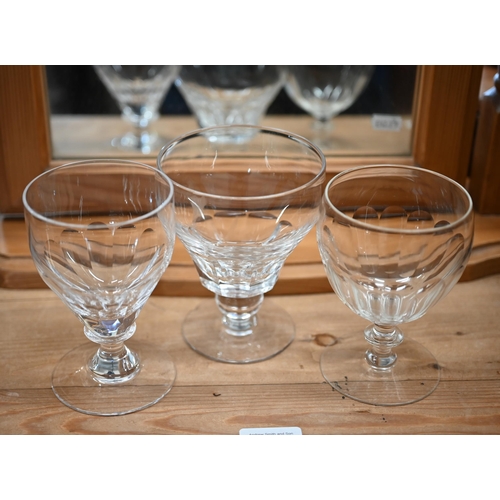 83 - Set of sixteen blown and cut wine glasses, on waisted stems to/w five somewhat similar large serving... 