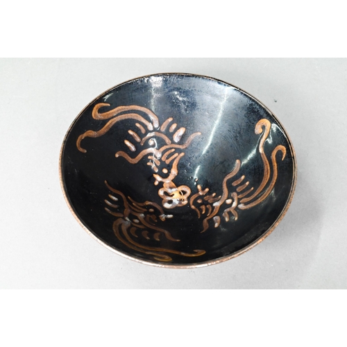 504 - A Chinese Southern Song style Jizhou stoneware bowl, the interior with three paper-cut phoenix desig... 