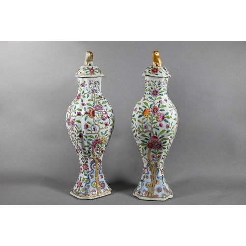 510 - A pair of 18th century Chinese famille rose garniture vases and covers with gilded animal finials, t... 