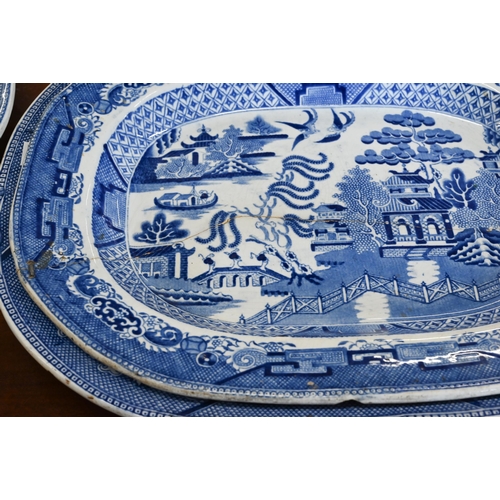 114 - Four early 19th century Ironstone Willow pattern meat dishes, 45/40 cm wide (one smaller dish repair... 