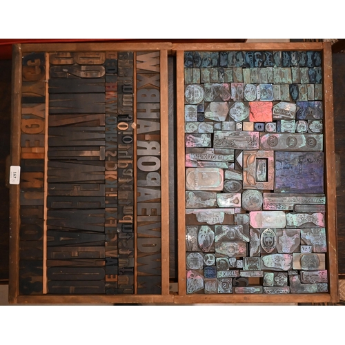 167 - Two trays of printing blocks - one with large letters, the other with emblems, insignia and motifs