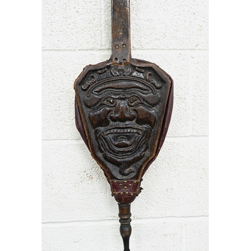 195 - Antique oak long-handled bellows, carved with grotesque mask, 88 cm