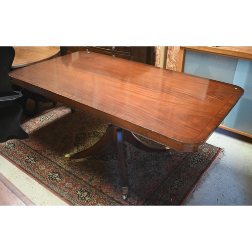 25 - # A Victorian style crossbanded mahogany veneered dining table, the rectangular top over a turned su... 