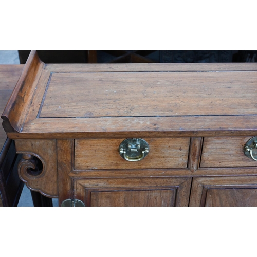 253 - A Chinese hardwood brass mounted altar-top side cabinet with two drawers over panelled cupboard door... 