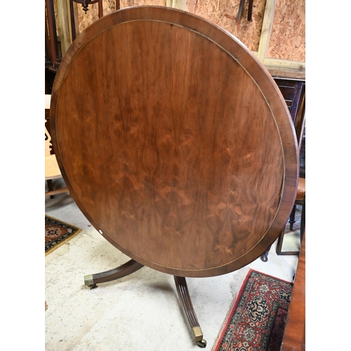 28 - A Victorian style circular crossbanded and brass band inlaid mahogany breakfast table on four moulde... 