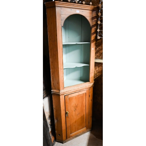 36 - An antique pine two-tier corner cupboard on plinth base