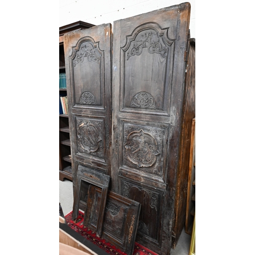 37 - A pair of antique carved oak armoire doors with armorial devices a/f