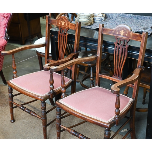 438 - A pair of Edwardian inlaid elbow chairs with pierced splats, puce fabric padded seats and turned leg... 