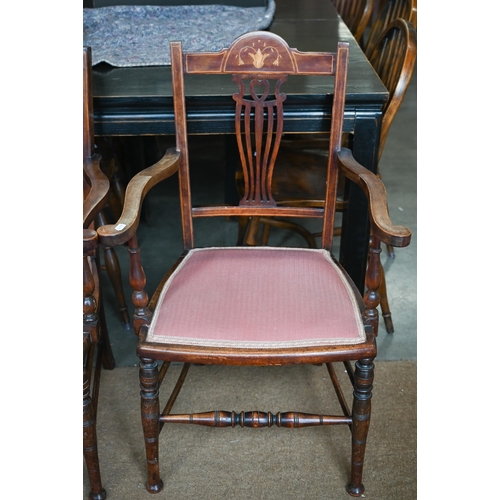 438 - A pair of Edwardian inlaid elbow chairs with pierced splats, puce fabric padded seats and turned leg... 