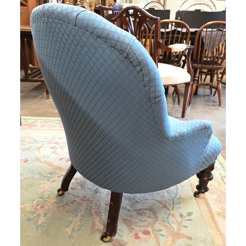 439 - A Victorian mahogany framed nursing chair, blue button back upholstery on turned front legs with cas... 