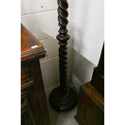 452 - An oak barley-twist standard lamp on circular platform base with bun feet, 164 cm high