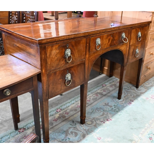 454 - A Regency mahogany sideboard with four drawers and brass lion mask ring handles raised on tapering s... 