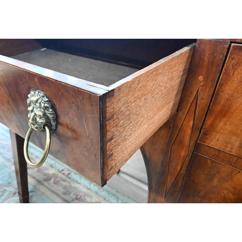 454 - A Regency mahogany sideboard with four drawers and brass lion mask ring handles raised on tapering s... 