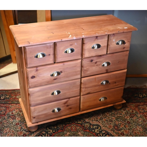 46 - A pine chest of four short over six further drawers, on turned feet (the top paint spattered), 92 x ... 