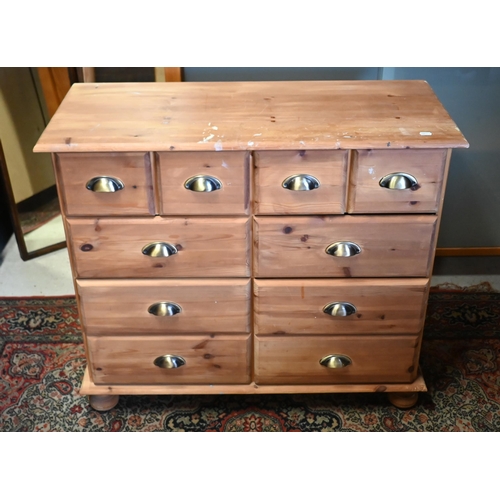46 - A pine chest of four short over six further drawers, on turned feet (the top paint spattered), 92 x ... 