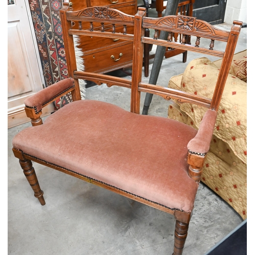 467 - # An Edwardian child's carved beech double chair-back settee with padded arms and seat, on turned su... 