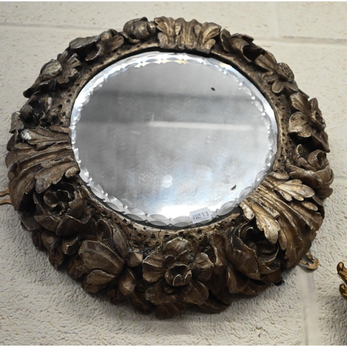 485 - A small antique ovall wall mirror in floral and foliate giltwood and gesso frame, 34 cm high x 28 cm... 