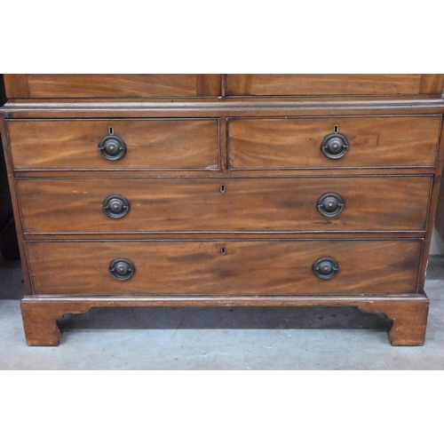 486 - A 19th century mahogany wardrobe/compactum, the top with panelled doors enclosing hanging rail on ch... 