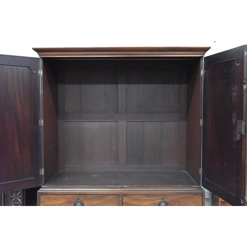 486 - A 19th century mahogany wardrobe/compactum, the top with panelled doors enclosing hanging rail on ch... 