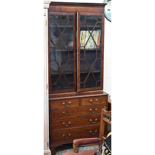 489 - A 19th century mahogany bookcase with astragal glazed doors raised on a chest base with two short an... 