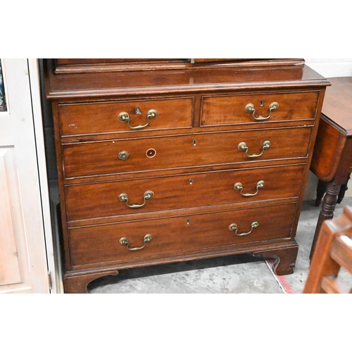 489 - A 19th century mahogany bookcase with astragal glazed doors raised on a chest base with two short an... 