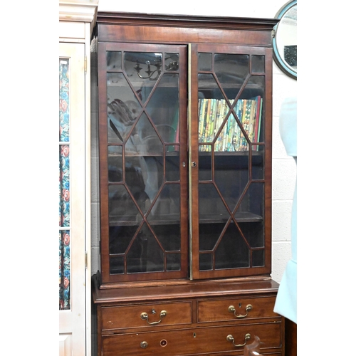 489 - A 19th century mahogany bookcase with astragal glazed doors raised on a chest base with two short an... 