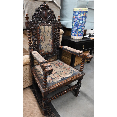 495 - Antique oak open armchair, the barleytwist frame supporting well carved oak leaf design back and lio... 