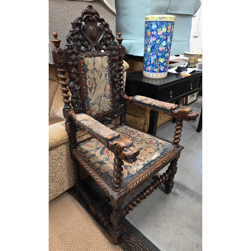 495 - Antique oak open armchair, the barleytwist frame supporting well carved oak leaf design back and lio... 